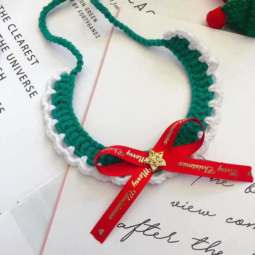 Green and white crocheted wool pet collar with red Christmas ribbon. Simple and stylish handmade holiday accessory for pets.