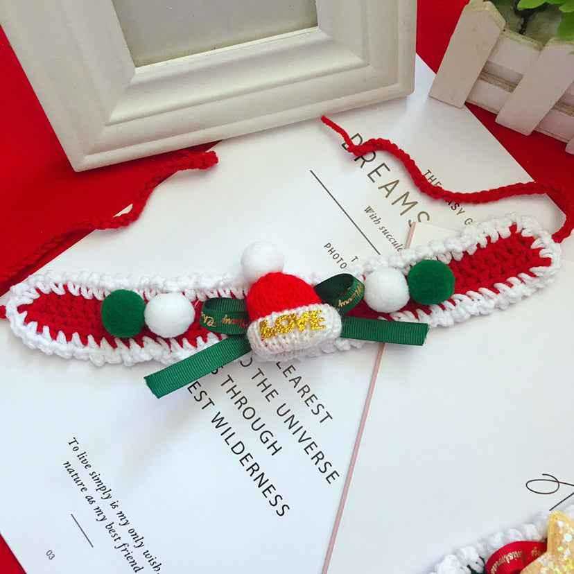 Red and white wool pet collar with green ribbon and mini Santa hat. Handmade Christmas accessory for stylish pets.